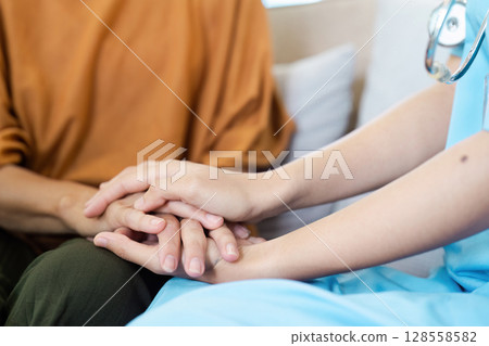 Compassionate Healthcare Professional Comforting Patient with a Gentle Touch in a Medical Setting 128558582