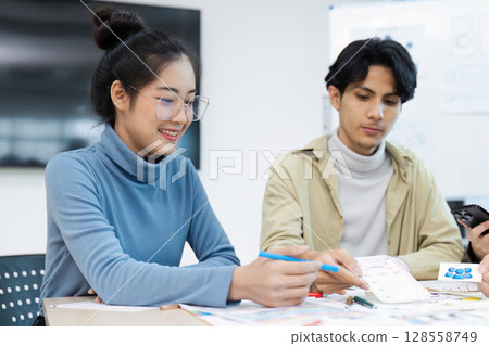 Creative Team Collaborating on UX UI Design Project in Modern Office Environment Creative Team Collaborating on UX UI Design Project in Modern Office Environment 128558749