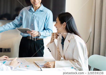 Professional Business Meeting with Smiling Colleague Discussing strategy in a Modern Office Setting Professional Business Meeting with Smiling Colleague Discussing strategy in a Modern Office Setting 128559138