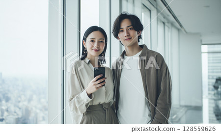 Young employee checking schedule on smartphone Young employee checking schedule on smartphone 128559626