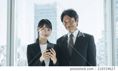 Young employee checking schedule on smartphone Young employee checking schedule on smartphone 128559627