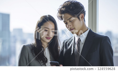 Young employee checking schedule on smartphone Young employee checking schedule on smartphone 128559628