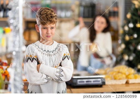 Portrait of capricious, offended boy whose mother forbade him to buy candy in store 128560099