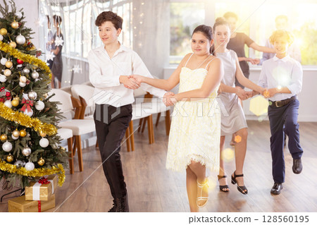 Teenagers performing cheerful polka during Christmas event at college 128560195
