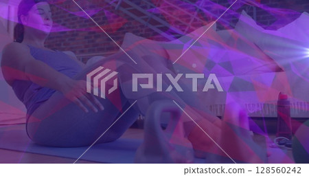 Image of network of connections over woman doing crunches exercising at home 128560242