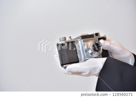 Image of an appraiser evaluating a camera Image of an appraiser evaluating a camera 128560271