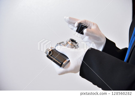 Image of an appraiser evaluating a camera Image of an appraiser evaluating a camera 128560282