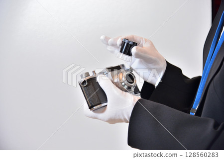 Image of an appraiser evaluating a camera Image of an appraiser evaluating a camera 128560283