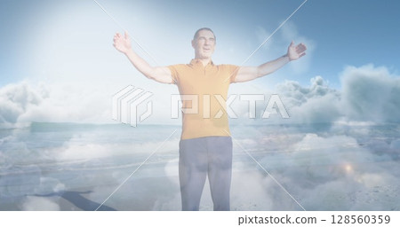 Image of glowing light over happy senior man by seaside Image of glowing light over happy senior man by seaside 128560359