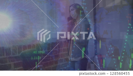 Image of data processing over woman talking on smartphone wearing face mask 128560455