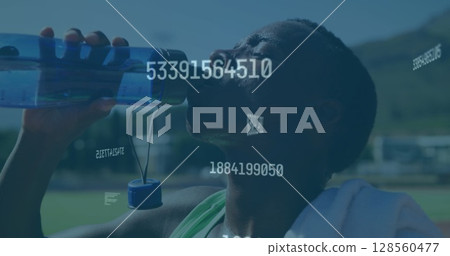 Image of digital data processing over male athlete drinking water 128560477