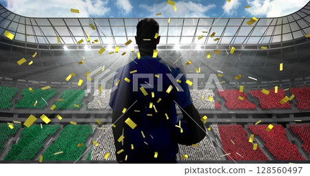 Golden confetti falling over rear view of male rugby player against sports stadium Golden confetti falling over rear view of male rugby player against sports stadium 128560497