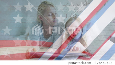 American flag pattern and constitution text against caucasian mother and daughter reading a book 128560528