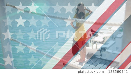 American flag design pattern and multiple stars against woman standing on a wooden pier American flag design pattern and multiple stars against woman standing on a wooden pier 128560541