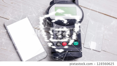 Image of network of connections and security padlock on shield over payment terminal 128560625