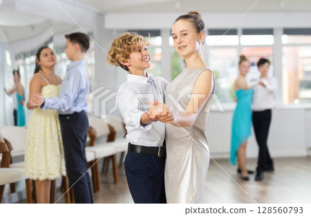 Boy and girl dancing waltz in studio Boy and girl dancing waltz in studio 128560793