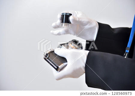 Image of an appraiser evaluating a camera Image of an appraiser evaluating a camera 128560973
