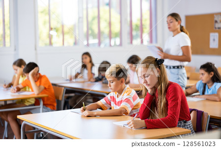 Girl and boy exercising in classroom Girl and boy exercising in classroom 128561023