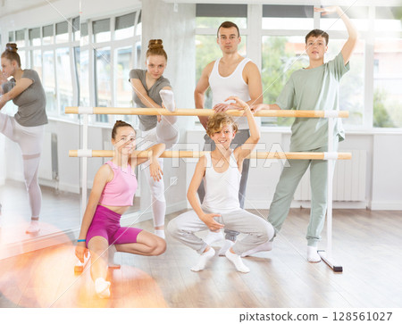 Teenage boys and girls posing with ballet-master in dancehall Teenage boys and girls posing with ballet-master in dancehall 128561027