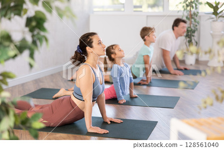 Family with two children doing yoga in studio Family with two children doing yoga in studio 128561040