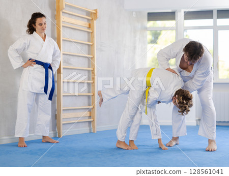 Father sparring with preteen son during martial arts training session Father sparring with preteen son during martial arts training session 128561041