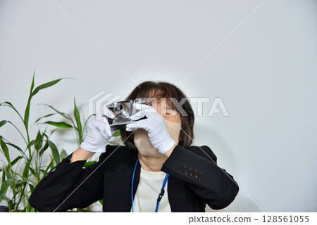 Image of an appraiser evaluating a camera Image of an appraiser evaluating a camera 128561055