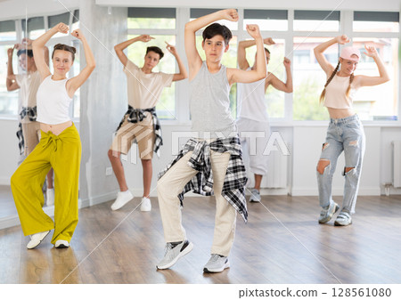 Teenage boy dancing hip hop in group 128561080
