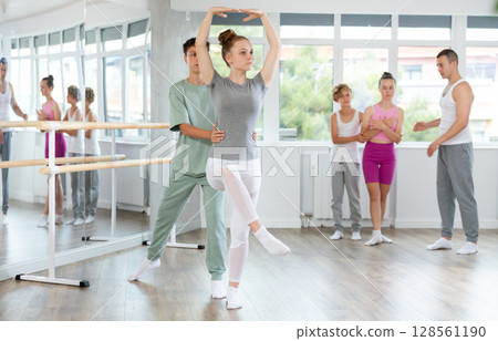 Boy and girl in pair train to perform ballet dance during rehearsal in studio 128561190