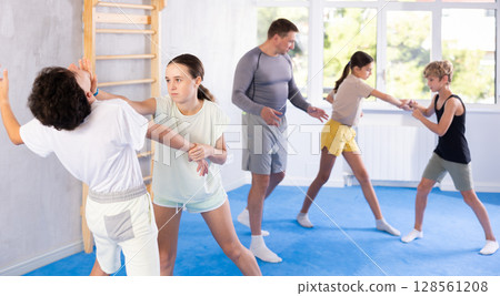 Boy and girl practicing self-defense techniques 128561208