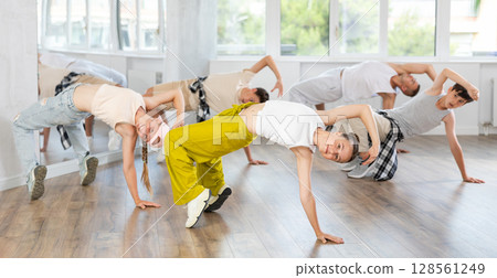 Teenage girl practicing hip-hop floor-works in training hall 128561249