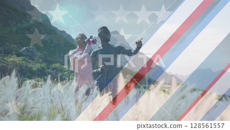 Image of american flag over man and woman taking break during exercise in mountains 128561557