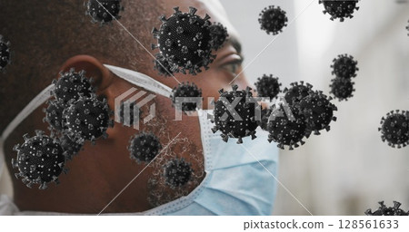 Image of covid 19 cells over man wearing face mask 128561633