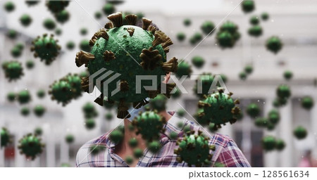 Image of covid 19 cells over caucasian man wearing face mask 128561634