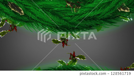 Decorative with spruce branches, holly and red berries against grey background Decorative with spruce branches, holly and red berries against grey background 128561719