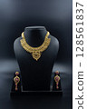 Traditional Gold Necklace with Earrings on Black Display Stand 128561837