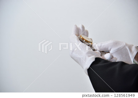 Image of an appraiser evaluating a watch Image of an appraiser evaluating a watch 128561949