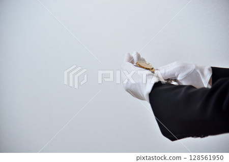 Image of an appraiser evaluating a watch Image of an appraiser evaluating a watch 128561950