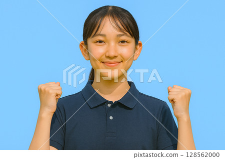 Junior high school student doing a fist pump and blue sky Junior high school student doing a fist pump and blue sky 128562000