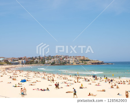 December 16, 2009. Sydney, Australia. Bondi Beach on a sunny day, bustling with sunbathers and swimmers enjoying the iconic sandy shores and clear blue waters. December 16, 2009. Sydney, Australia. Bondi Beach on a sunny day, bustling with sunbathers and swimmers enjoying the iconic sandy shores and clear blue waters. 128562003