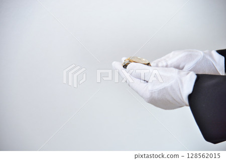 Image of an appraiser evaluating a watch Image of an appraiser evaluating a watch 128562015