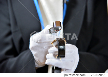 Image of an appraiser evaluating a watch Image of an appraiser evaluating a watch 128562053
