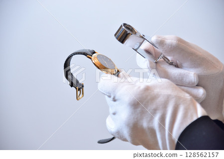 Image of an appraiser evaluating a watch 128562157