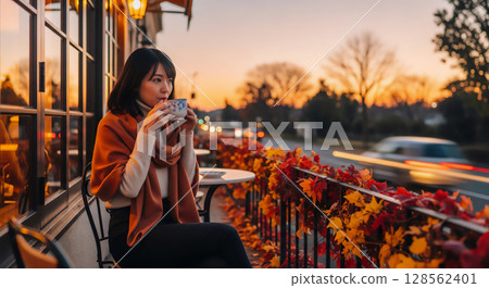 Women's relaxing time on the autumn terrace, cafe time 128562401