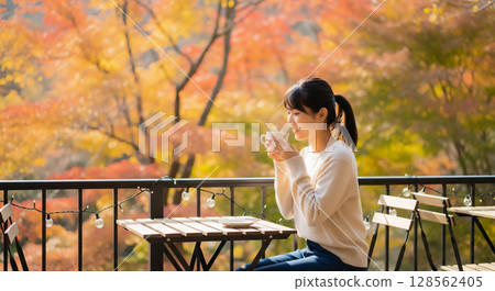 Women's relaxing time on the autumn terrace, cafe time 128562405