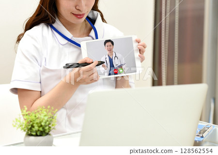 Asian female nurse providing online medical care 128562554
