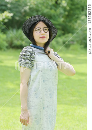 A young woman cooling her neck with a neck cooling ring A young woman cooling her neck with a neck cooling ring 128562556