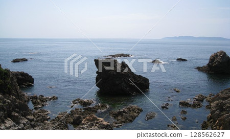 The Sea of Japan and the orange rock lilies blooming on the oddly shaped rocks of the scenic Sasagawa Nagare River The Sea of Japan and the orange rock lilies blooming on the oddly shaped rocks of the scenic Sasagawa Nagare River 128562627