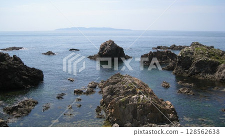 The Sea of Japan and the orange rock lilies blooming on the oddly shaped rocks of the scenic Sasagawa Nagare River The Sea of Japan and the orange rock lilies blooming on the oddly shaped rocks of the scenic Sasagawa Nagare River 128562638