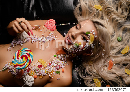 Colorful candy body art showcases creativity and beauty in a studio setting Colorful candy body art showcases creativity and beauty in a studio setting 128562671