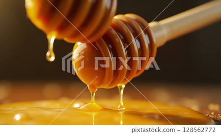 Dual Honey Dippers Dripping Golden Viscous Honey Close-up 128562772